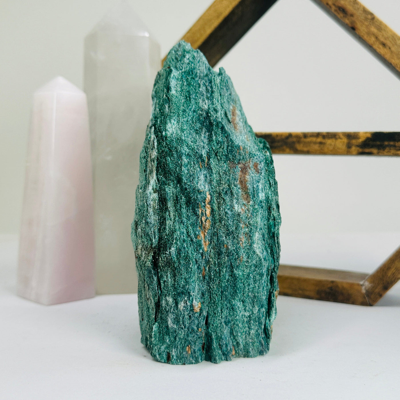 fuchsite cut base with decorations in the background