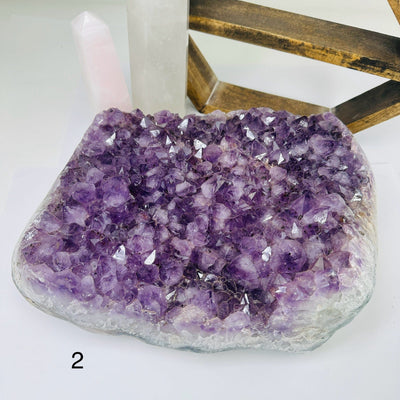amethyst cluster with decorations in the background