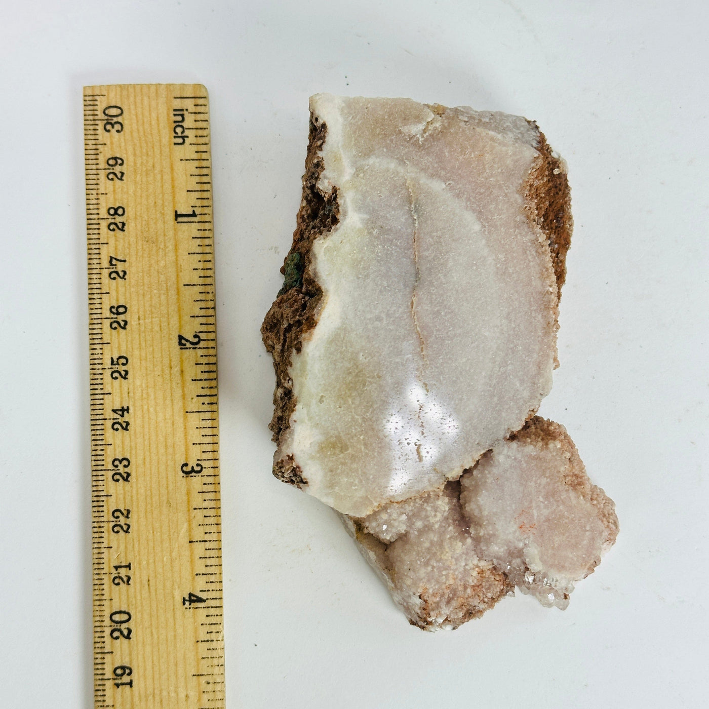 pink amethyst  next to a ruler for size reference