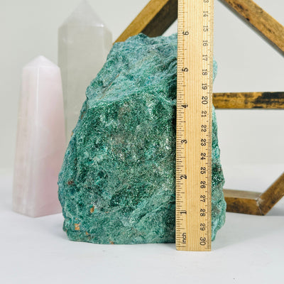 fuchsite cut base next to a ruler for size reference