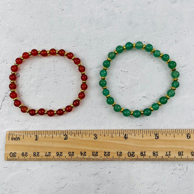 bracelet next to a ruler for size reference 
