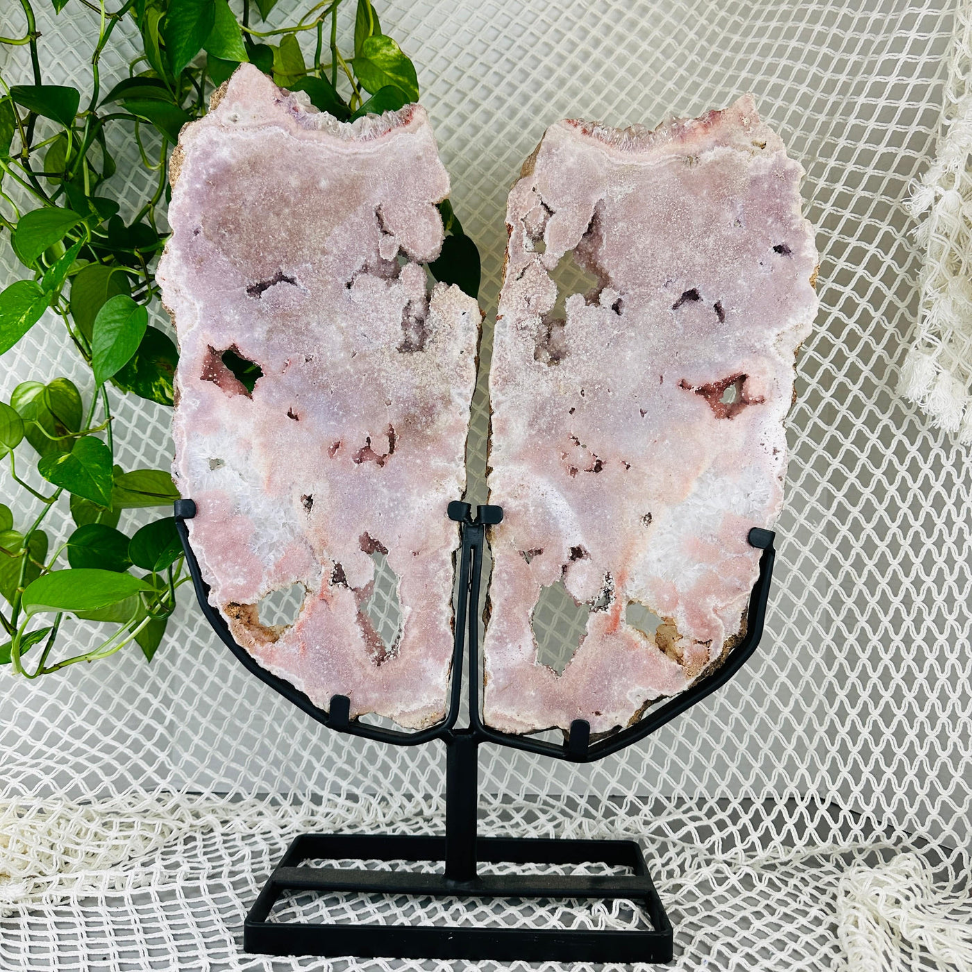 backside of Pink amethyst wings with decorations in the background
