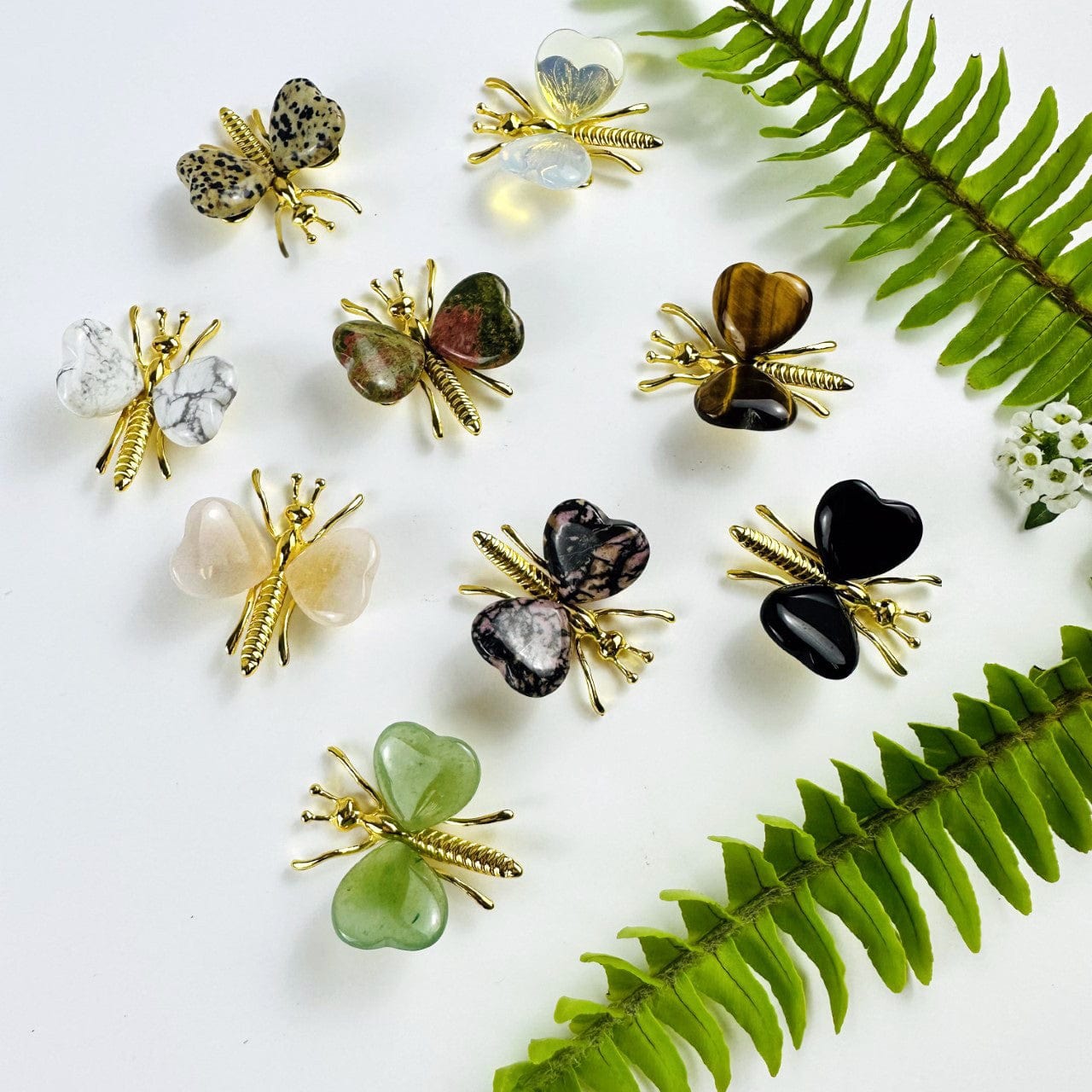 Gemstone Butterflies with Gold Tone Body on a table showing the assorted stones we carry