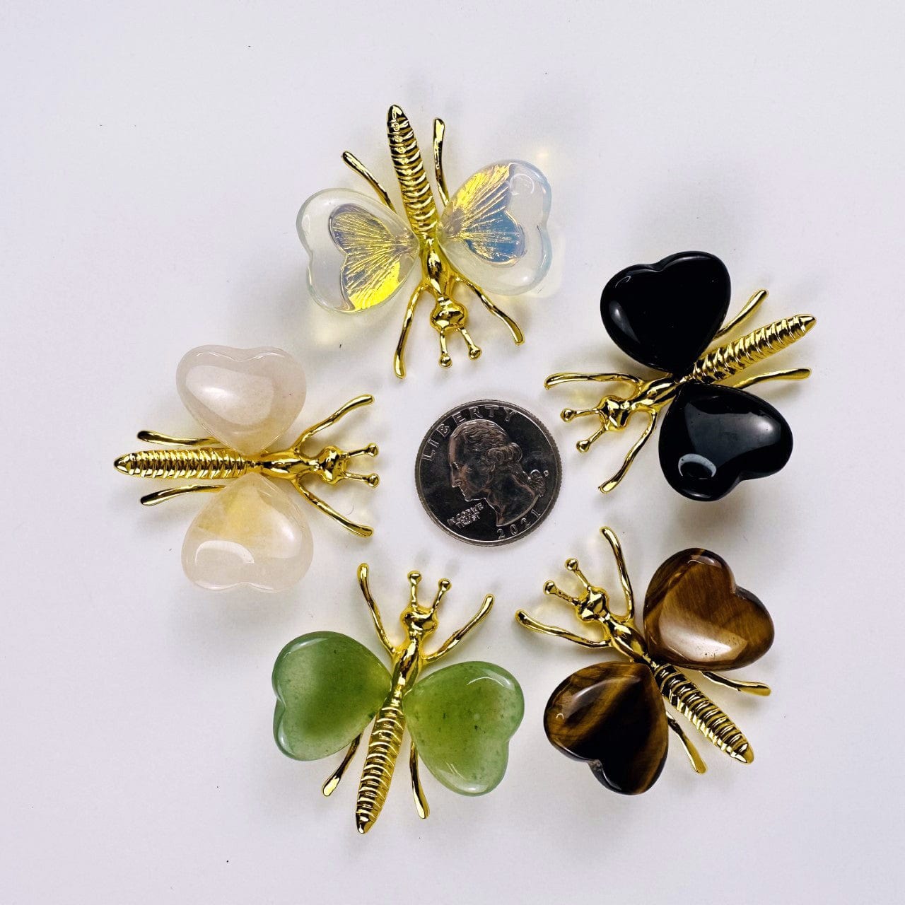Gemstone Butterflies with Gold Tone Body around a quarter for size reference