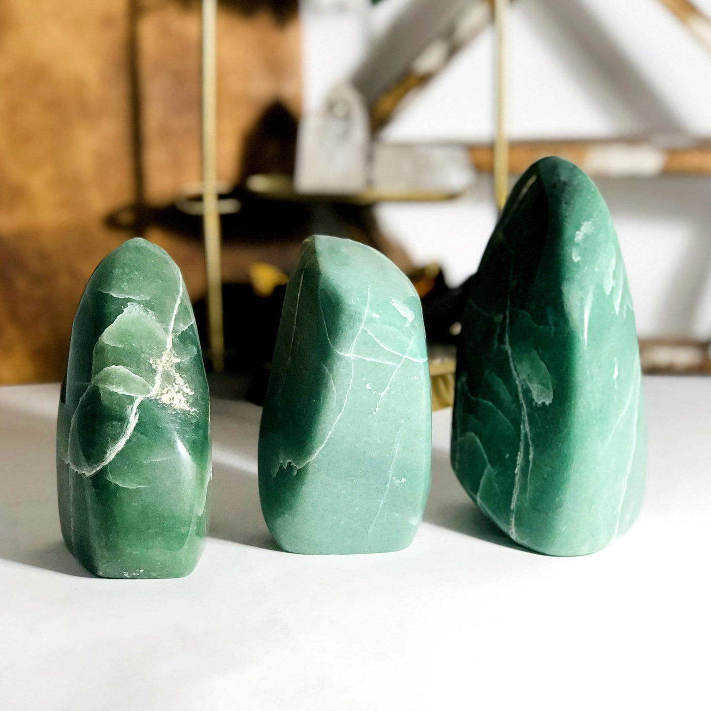 3 aventurine cut bases with shelves blurred in the background