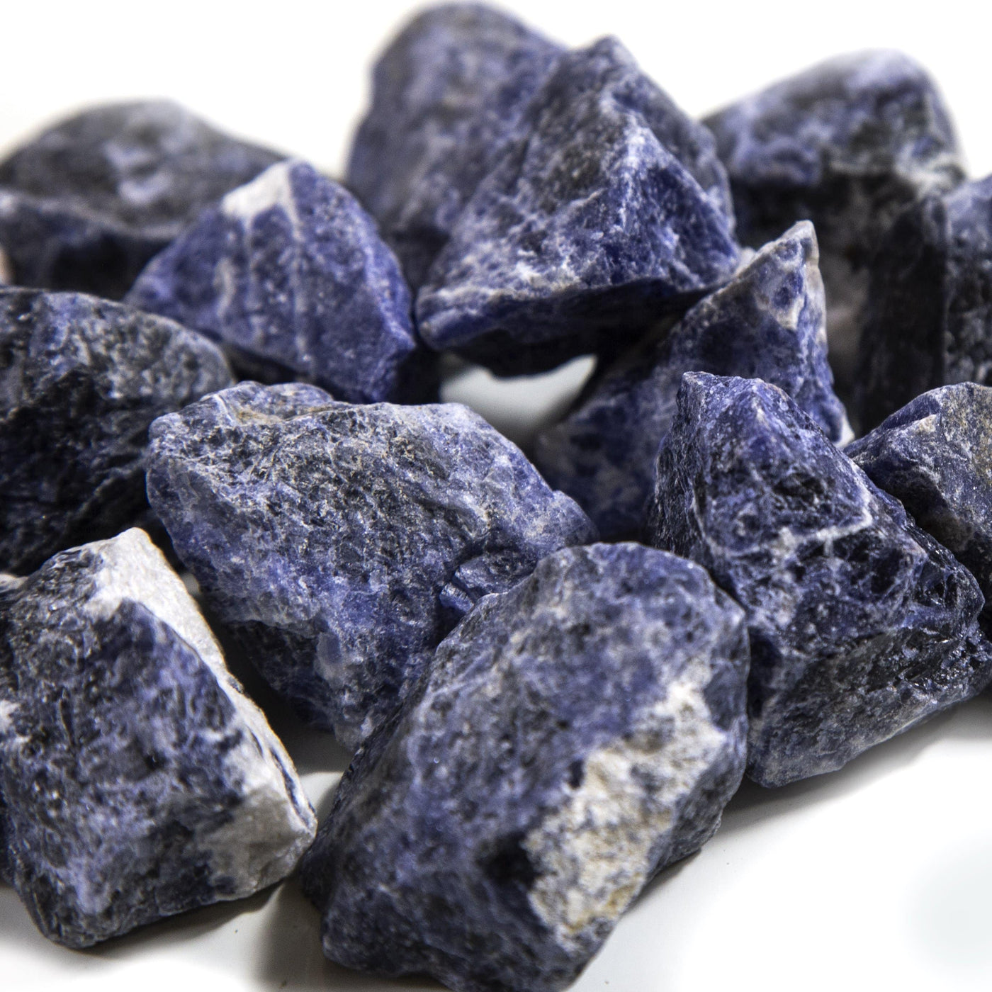 close up of many sodalite rough stones in a pile for details
