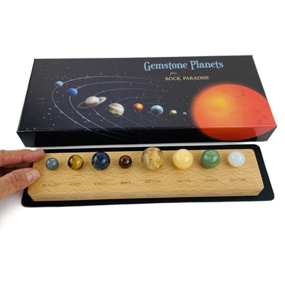 Gemstones planet box with a mat and wood base with all the stone planets in place - with a hand for sizing