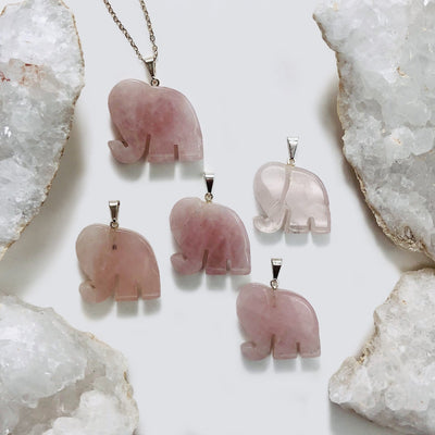 Elephant Gemstones Pendant Showing on Rose Quart Stone On a white background 