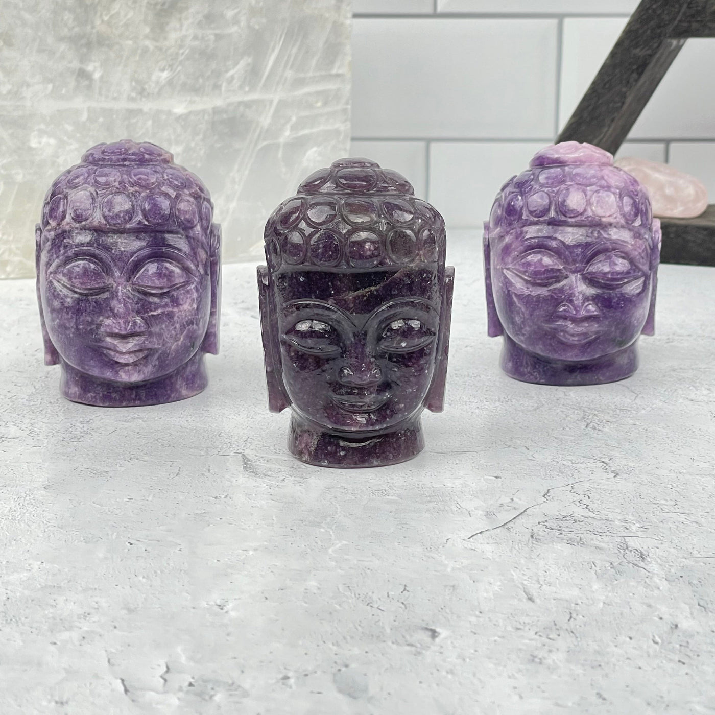 multiple carved buddha heads displayed to show the differences in the size and color shade 