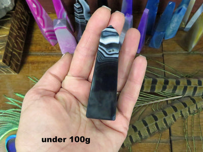 Picture of our black agate tower point being held, for size reference.