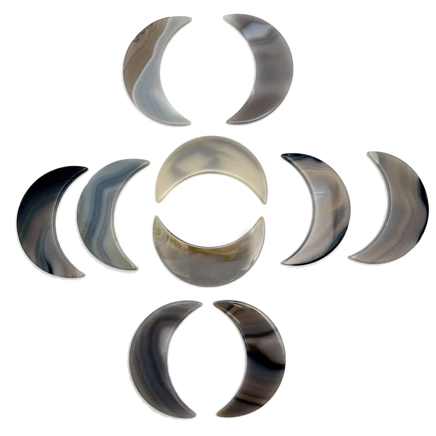 Ten natural agate moons displayed on a white surface.