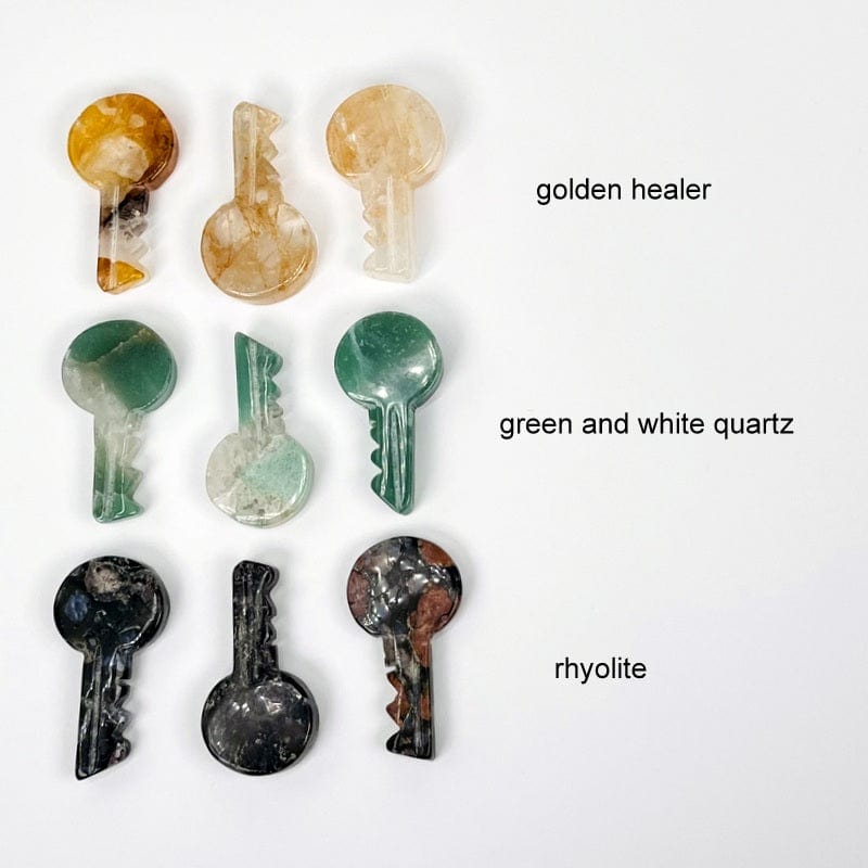 multiple golden healer, green and white quartz, and rhyolite gemstone keys showing the differences in the gemstones 