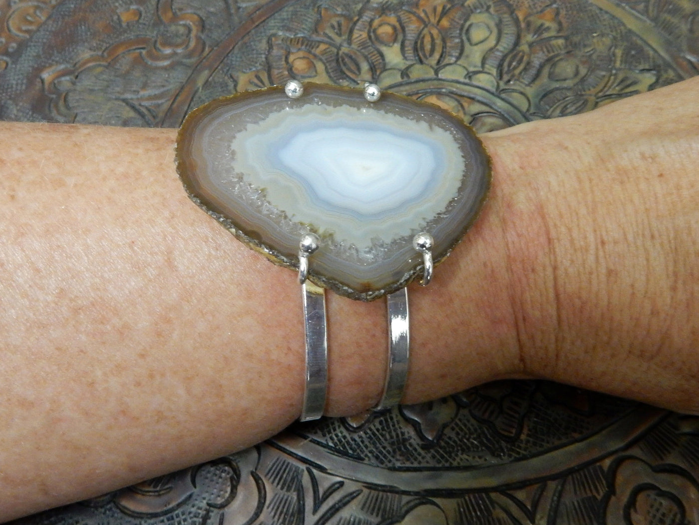 Natural Agate Slice with Adjustable Bracelet with silver on a wrist.