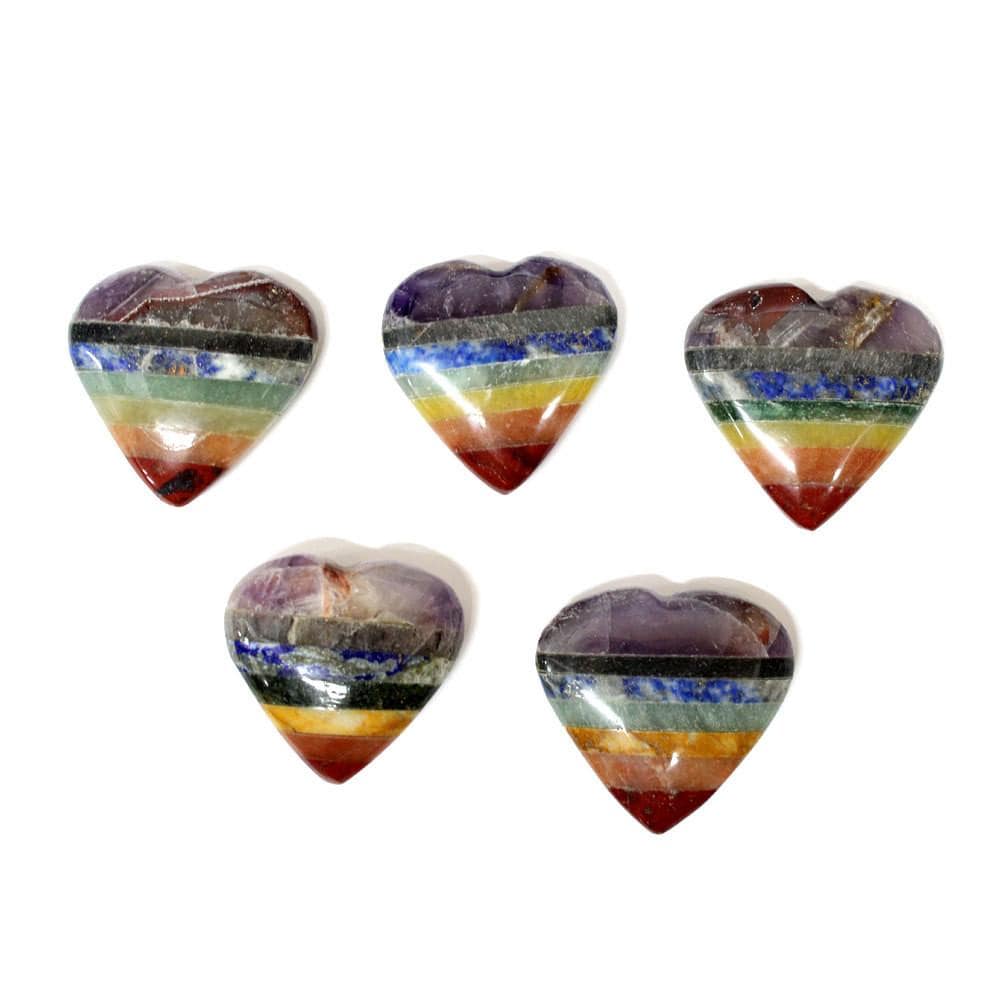 five seven chakra stone hearts laying flat on white background for possible variations 