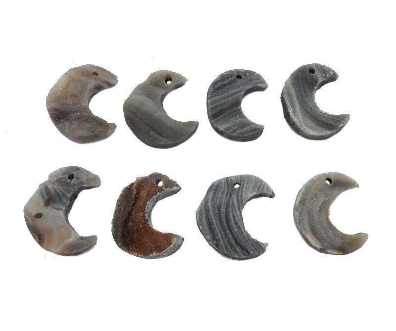 8 Raw Chalcedony Moon Crescents lined up on white background