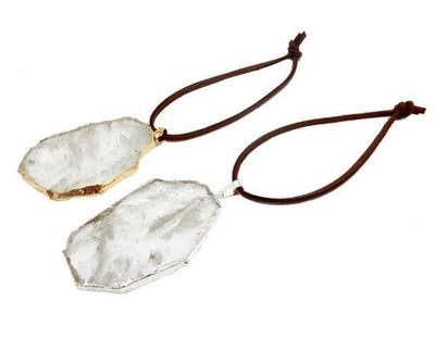 crystal quartz ornaments displayed in silver and gold with brown faux leather tie side view for thickness reference