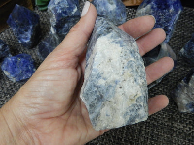 Sodalite Semi Polished Point in a hand for size reference