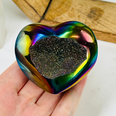 titanium coated heart with decorations in the background