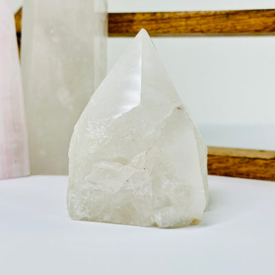 crystal quartz point with decorations in the background