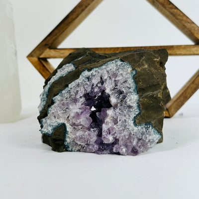 amethyst cluster with decorations in the background