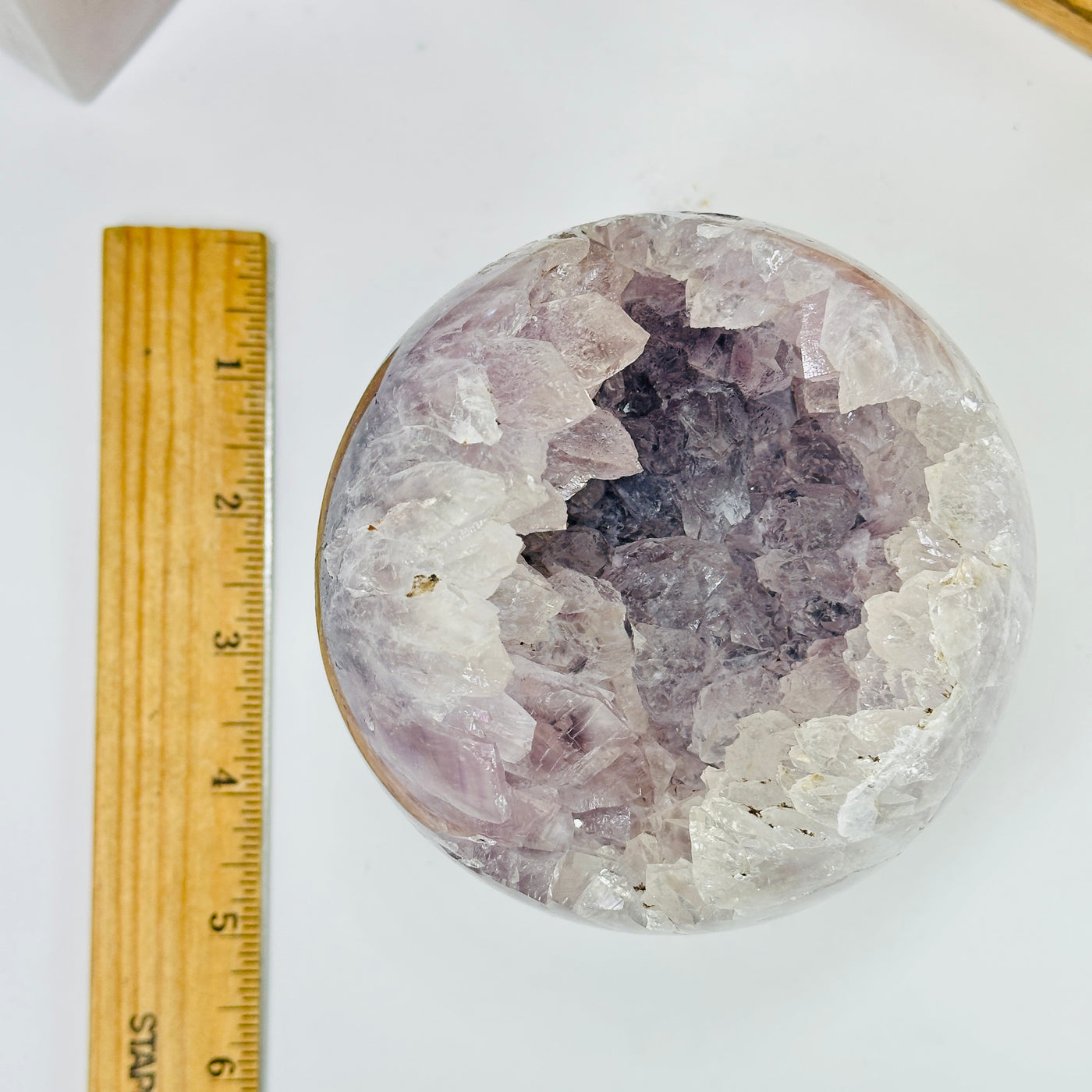 amethyst sphere next to a ruler for size reference