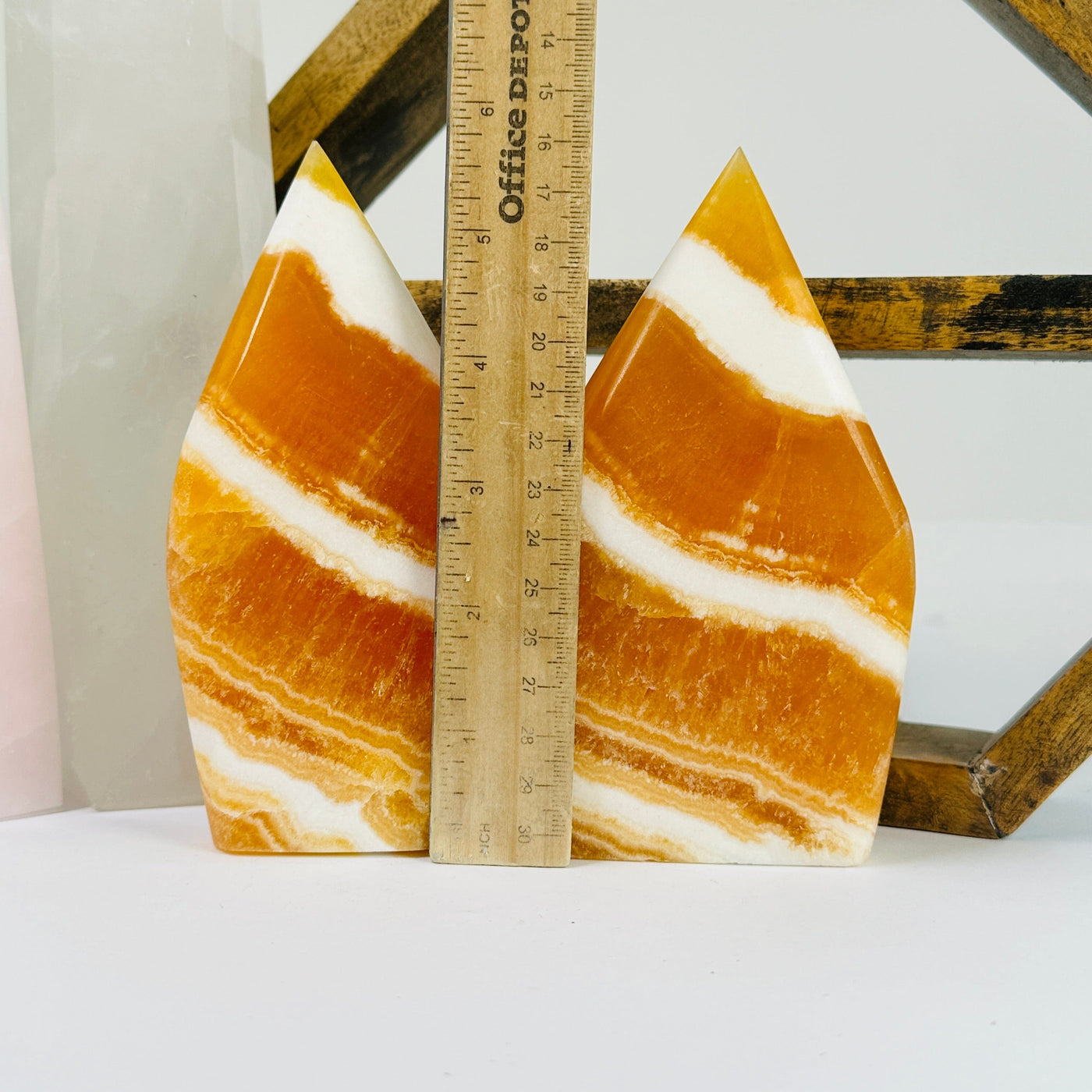 BANDED CALCITE POint with decorations in the background