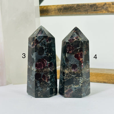 hematite point with decorations in the background