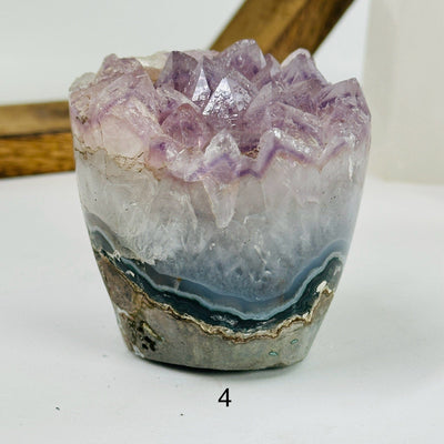 amethyst crystal flower with decorations in the background
