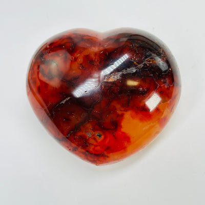 carnelian heart with decorations in the background