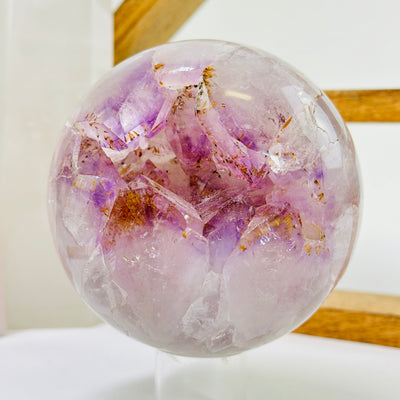 amethyst sphere with decorations in the background