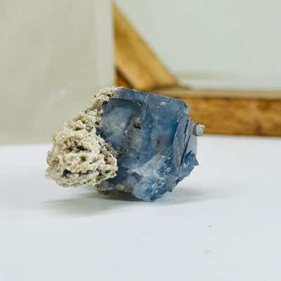 blue fluorite with decorations in the background