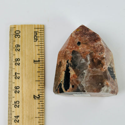 feldspar point next to a ruler for size reference