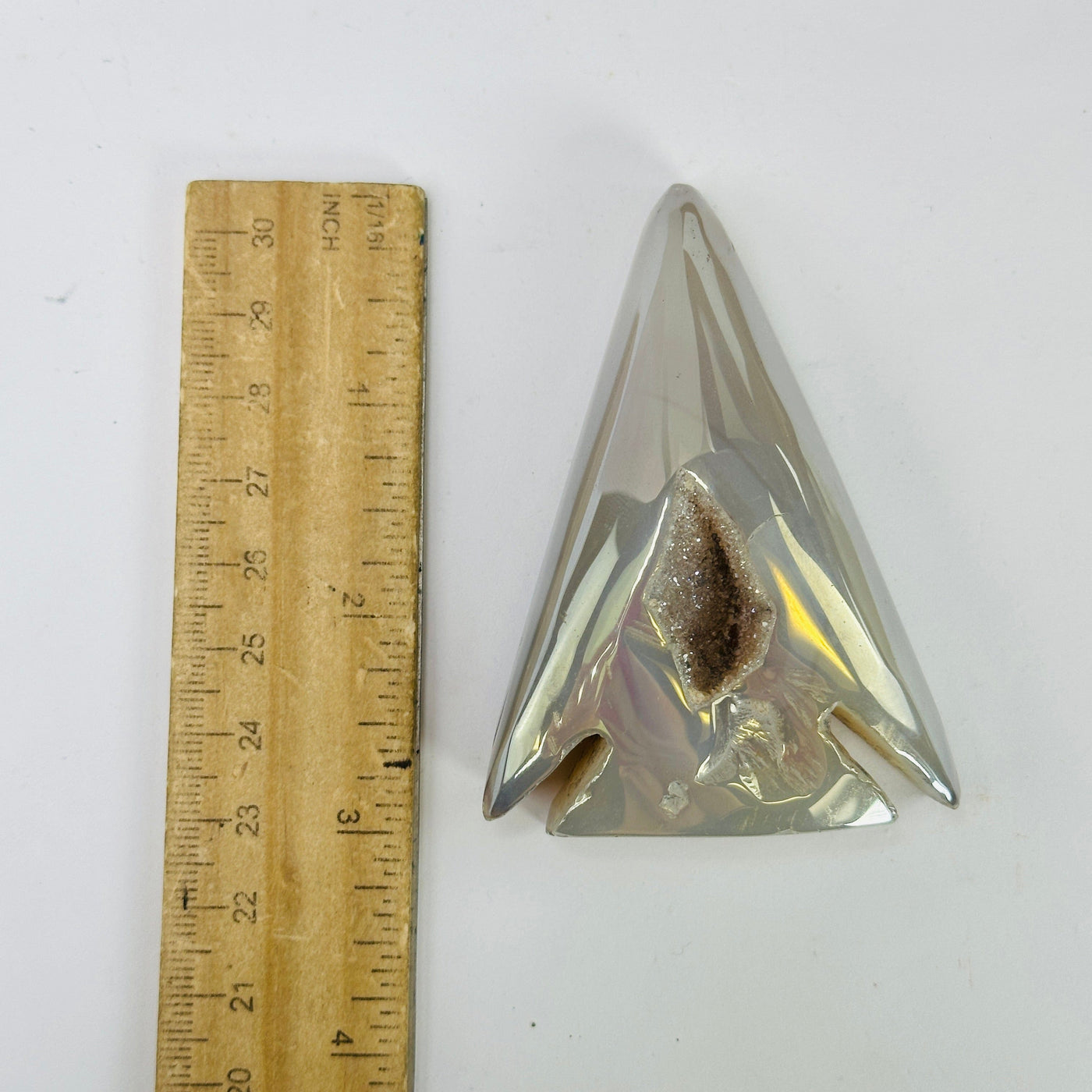 agate arrowhead next to a ruler for size reference