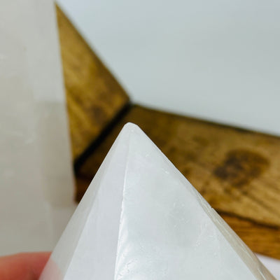 crystal quartz point with decorations in the background