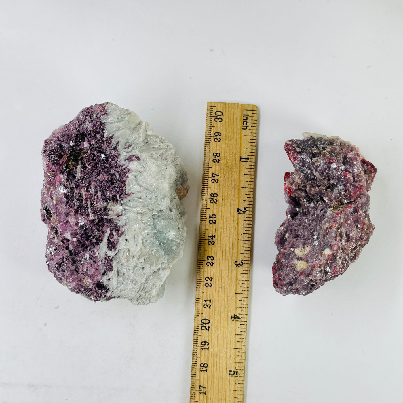 lepidolite cluster with decorations in the background