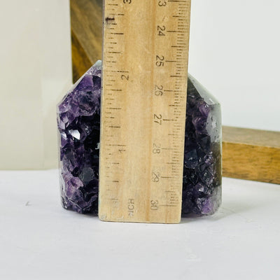 amethyst point next to a ruler for size reference