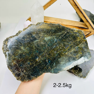 labradorite slab with decorations in the background