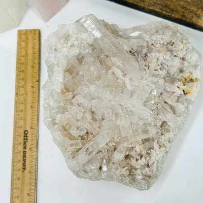 crystal quartz cluster next to a ruler for size reference