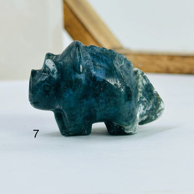 moss agate triceratops with decorations in the background