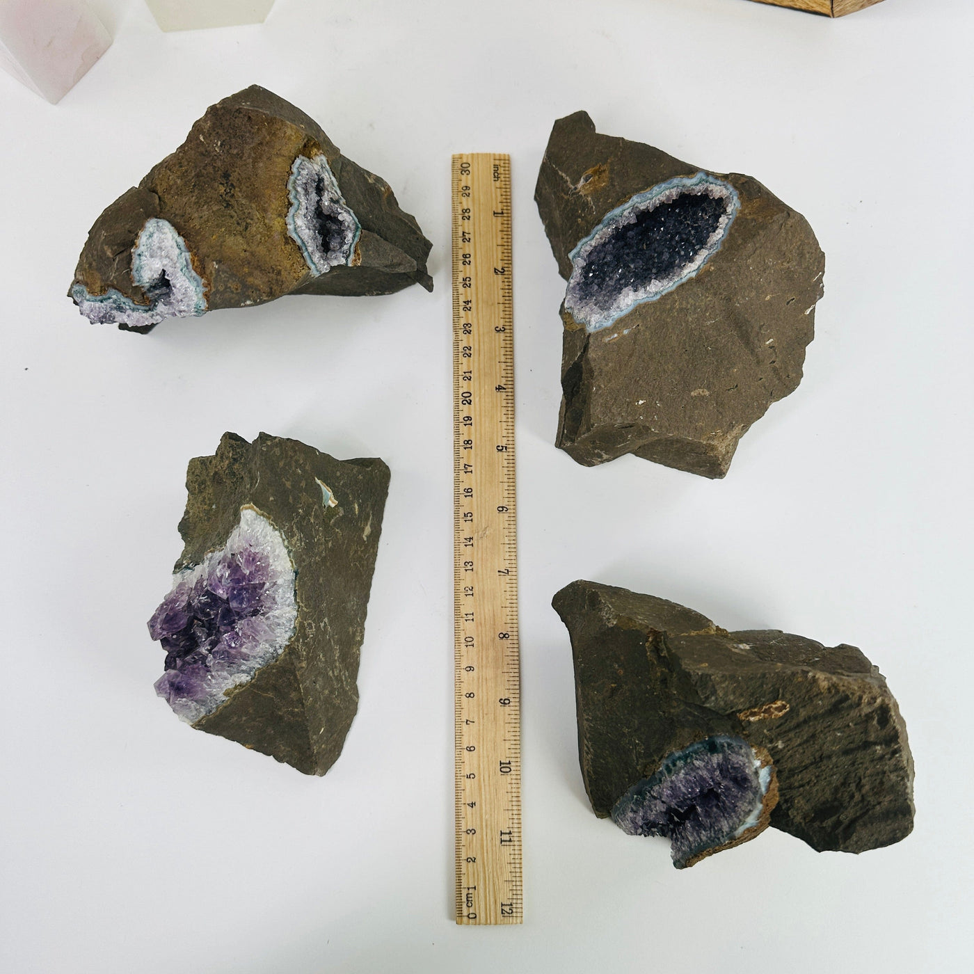 amethyst clusters next to a ruler for size reference