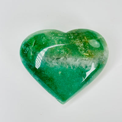 aventurine heart with decorations in  the background