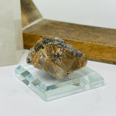 rutilated quartz with decorations in the background