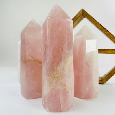 rose quartz points with decorations in the background