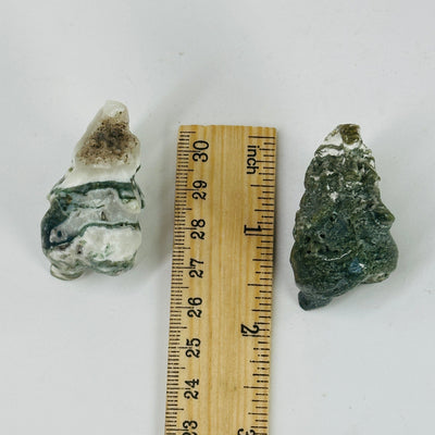 moss agate elephant next to a ruler for size reference
