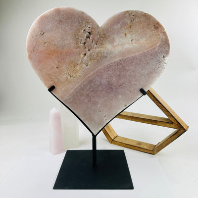 pink amethyst heart on stand with decorations in the background