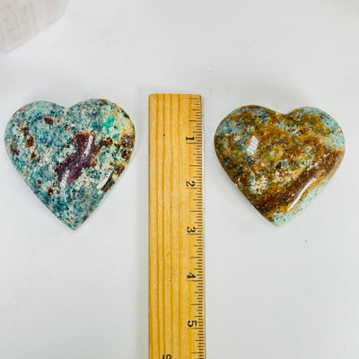 amazonite heart with decorations in the background