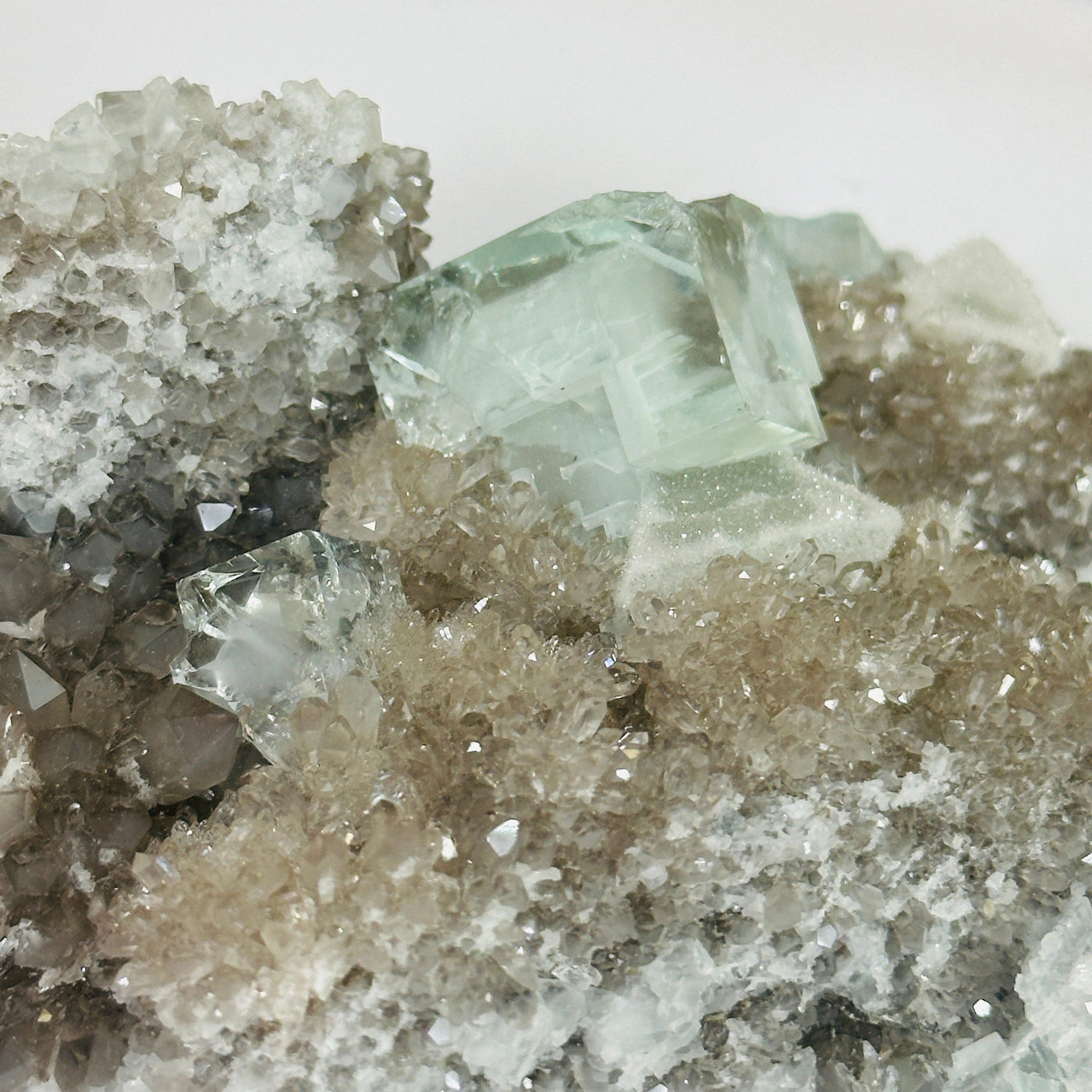 Blue fluorite crystal with decorations in the background