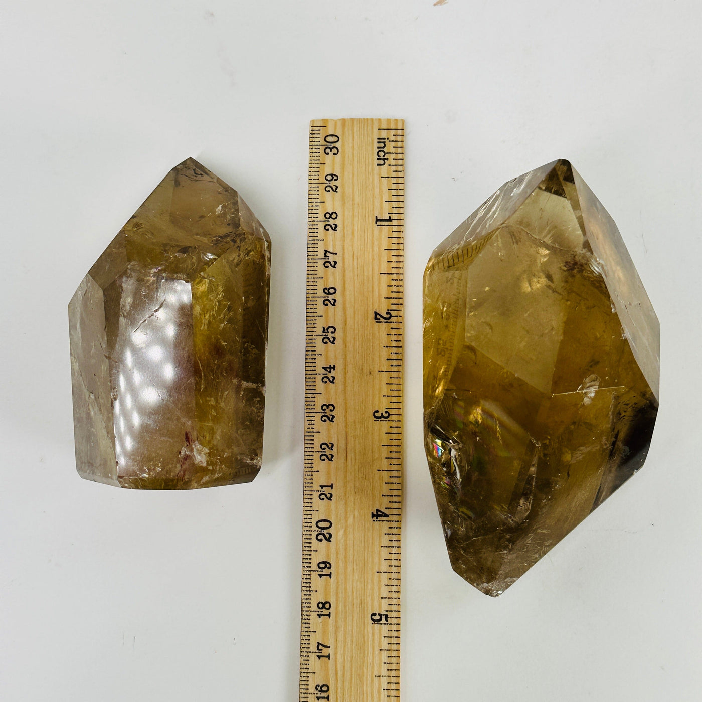 Citrine points next to a ruler for size reference