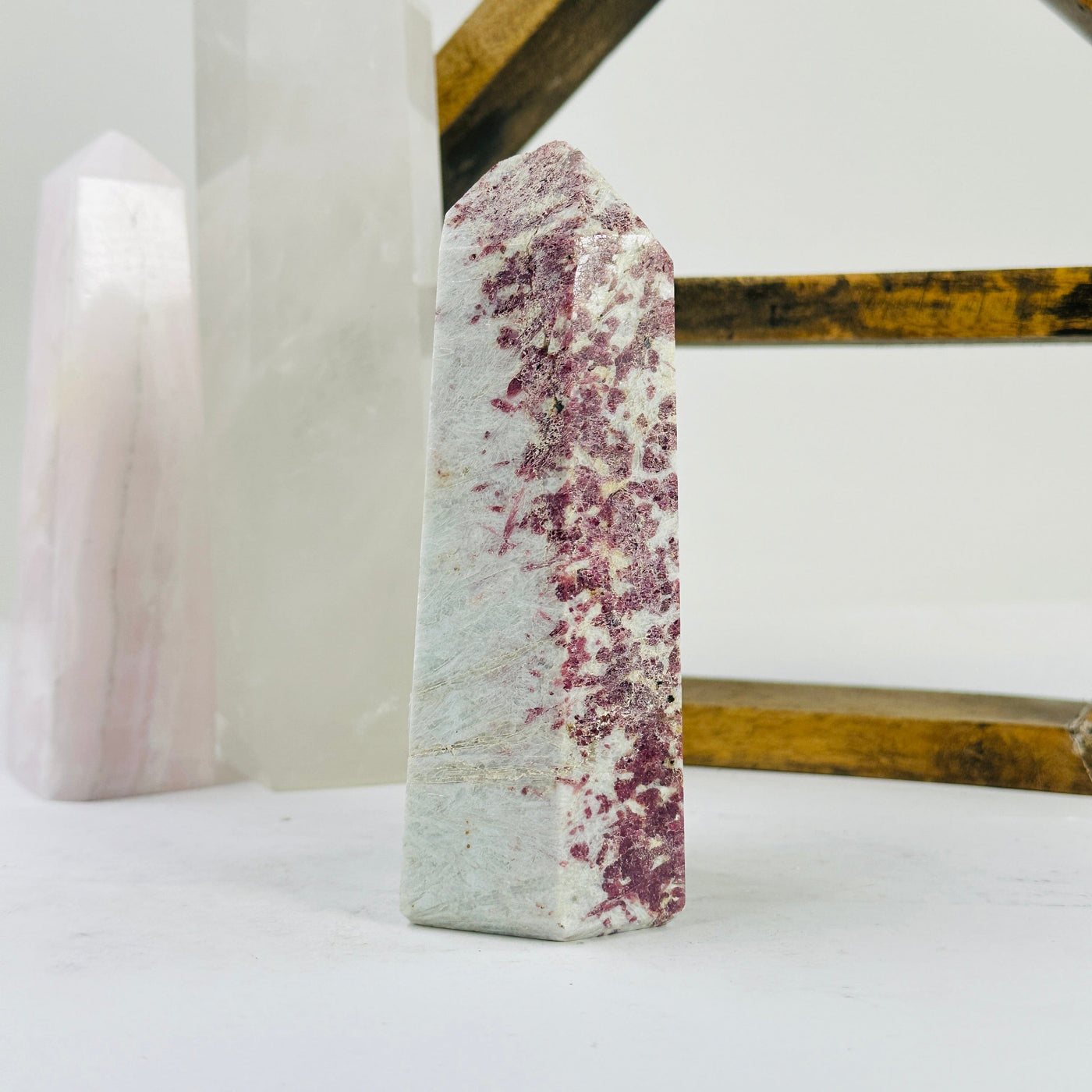 pink tourmaline point with decorations in the background