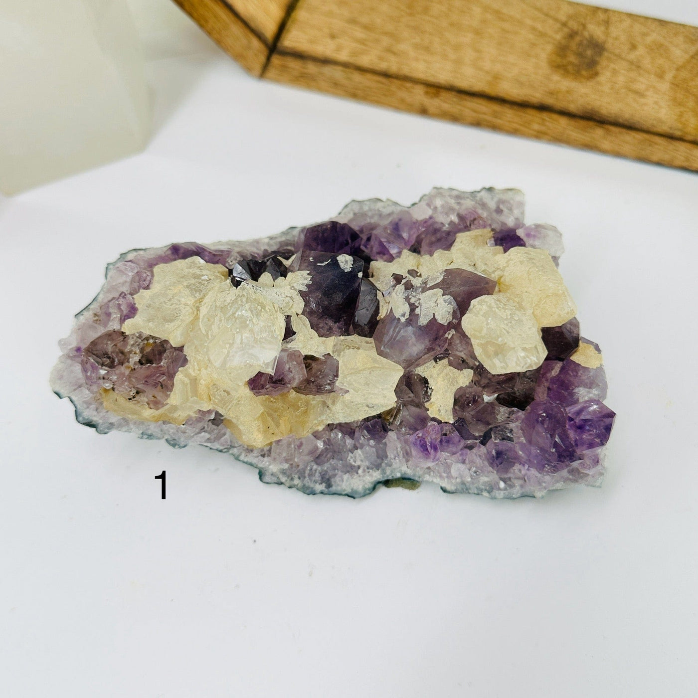 amethyst cluster with decorations in the background